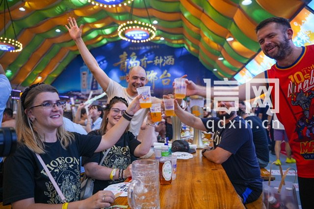 外国游客在啤酒大篷举杯共饮。（来源：金沙滩啤酒城）