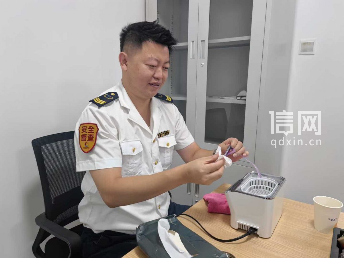 志愿者袁燊为居民清洗眼镜。（来源：信网）